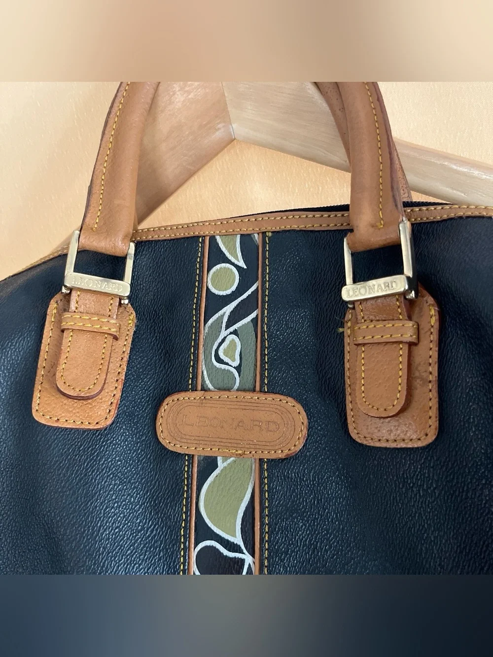 Black Leather Duffel Bag with Brown Trim and Olive Pattern Accent